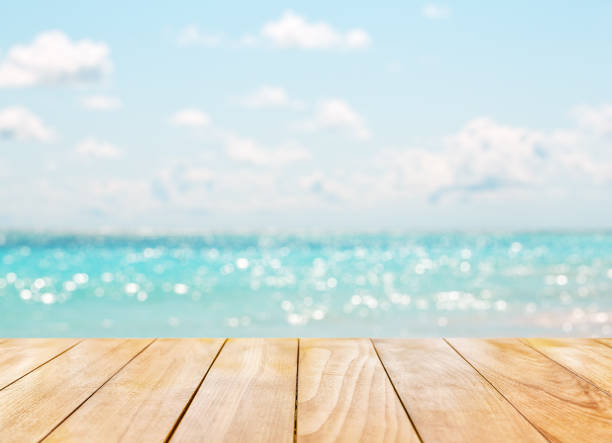 istock Wooden table top on blue sea 810113492