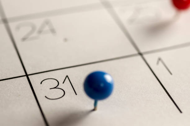 Last day of the month Close up shot of a calendar with a pin on the number 31 calendar deadline stock pictures, royalty-free photos & images