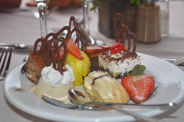 istock Many different cakes with cream and fruit stand on the plate. Breakfast in the hotel restaurant 810127770
