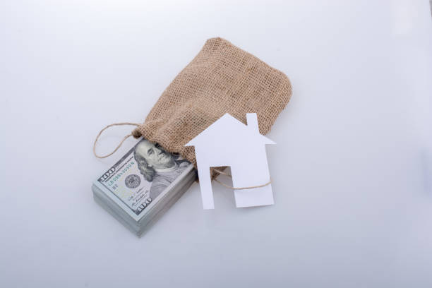 istock Paper house beside US dollar banknote 810130566