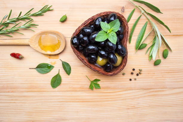 olive oil with cooking ingredients - cooking oil olive oil nutritional supplement spoon imagens e fotografias de stock