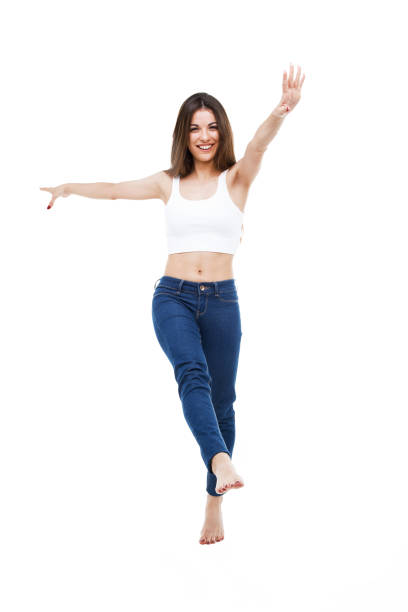 istock Beautiful young woman dancing over white background. 810159412