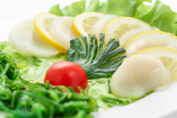 Sashimi of scallops, vegetables, lettuce, tomato, scallop over Sashimi of scallops, vegetables, lettuce, tomato, scallop over on white background salmon and red snapper stock pictures, royalty-free photos & images