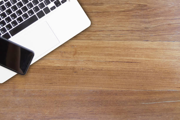 istock Smart phone and laptop on wooden. mock up. high angle view 810165746