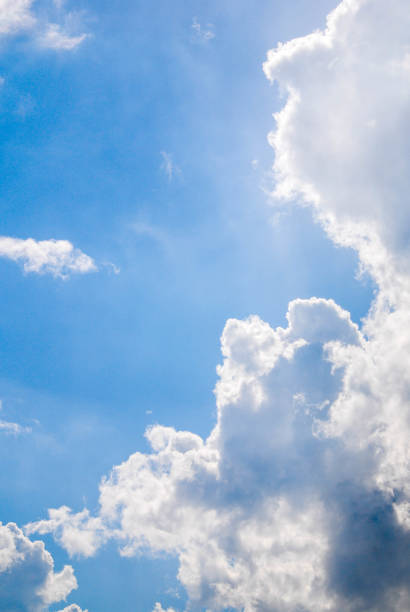 istock Fluffy white clouds against a bright blue sky on a Summers day 810166302