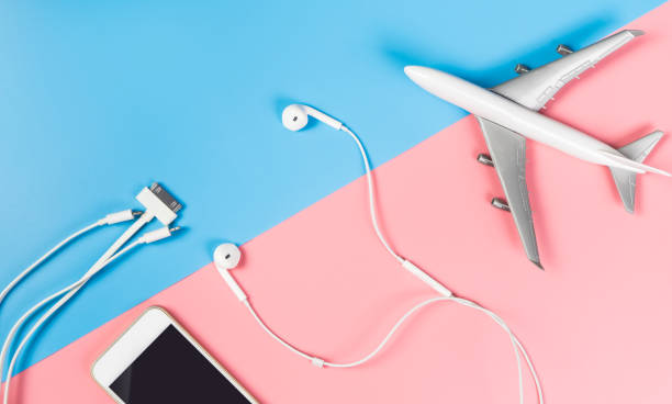 istock Smartphone accessories for traveling on the plane on blue and pink background 810171776