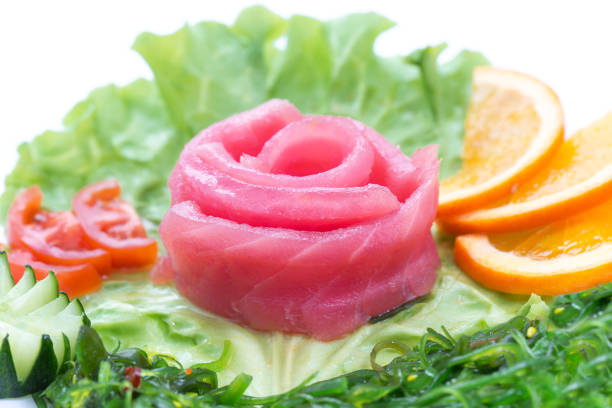 Sashimi of tuna, vegetables, lettuce, oranges, tuna Sashimi of tuna, vegetables, lettuce, oranges, tuna white background salmon and red snapper stock pictures, royalty-free photos & images