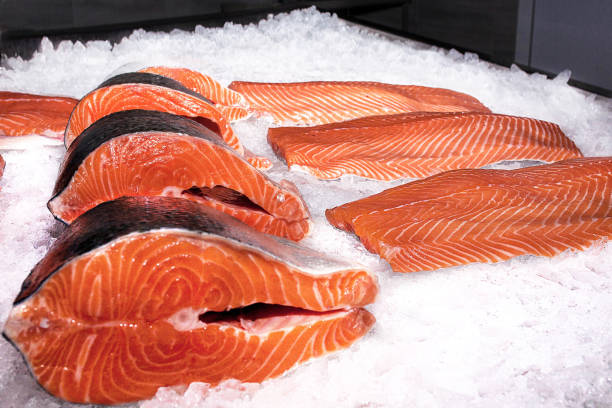 istock Salmon fillet next to steaks on ice 810175370