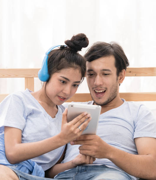 istock Young couple with headphones 810182364