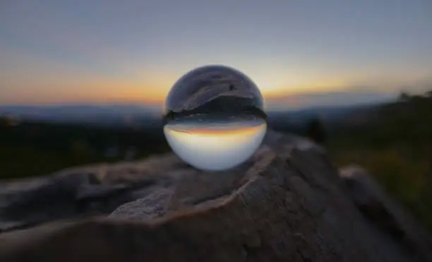 Glass ball reflecting mountain top