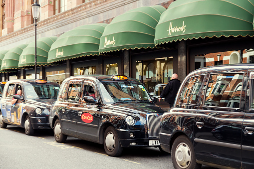 London, UK - June 09, 2017: Taxis waiting in a queue outside Harrods department store in London