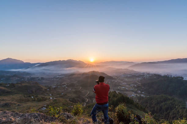 istock Photographer in action, clicking a beautiful Himalayan Sunrise. 810186398