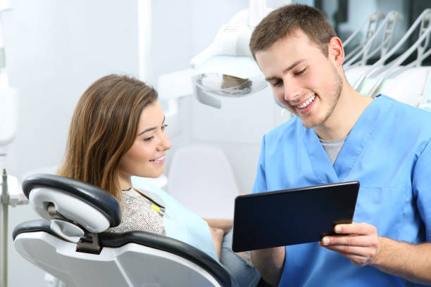 istock Dentist and patient commenting treatments in a tablet 810200620