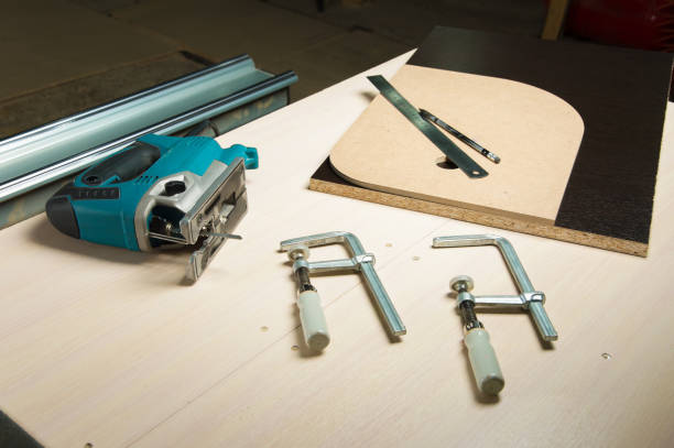 istock Prepared tool jigsaw with wood clamps and a pencil with a ruler lying 810227768