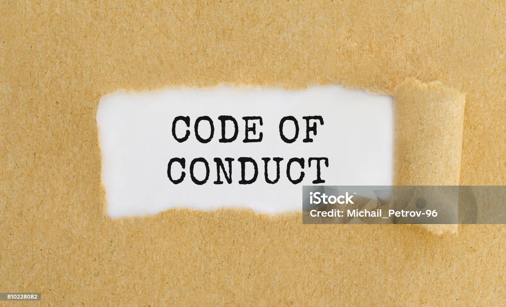 Text Code of Conduct appearing behind ripped brown paper. Coding Stock Photo