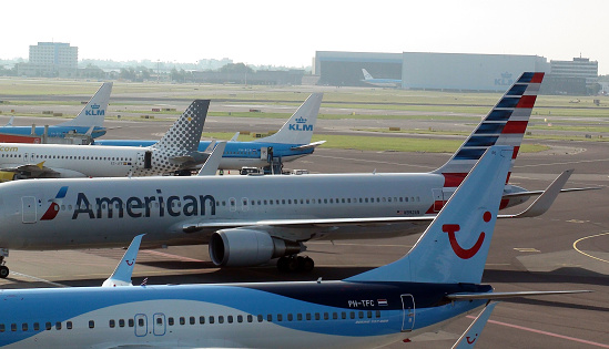 View Of Tuifly Netherlands Airplane,American Airlines Airplane,KLM Royal Dutch Airlines Airplane,Vueling Airlines Airplane Parked At Amsterdam Schiphol International Airport The Netherlands Europe