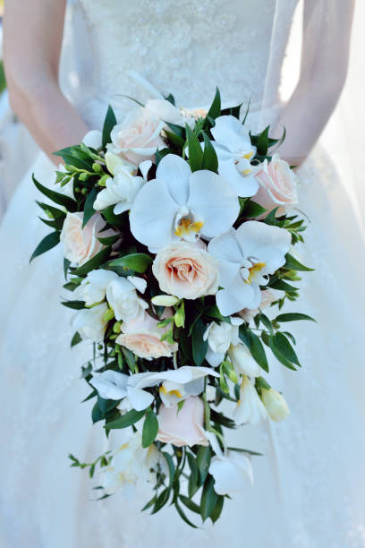 istock Beautiful bride is holding a wedding colorful bouquet 810274884
