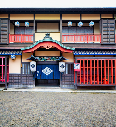 Japanese Edo village inn exterior movie set at Toei Studios Kyoto on an overcast day.