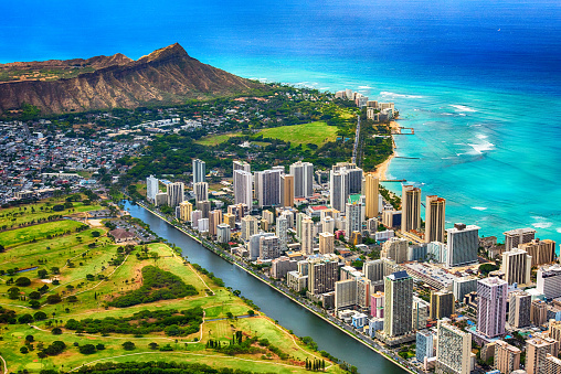 The beautiful coastline of the Waikiki area of Honolulu Hawaii with the volcanic crater, Diamond Head, in the background shot from an altitude of about 1000 feet during a helicopter photo flight over the island.