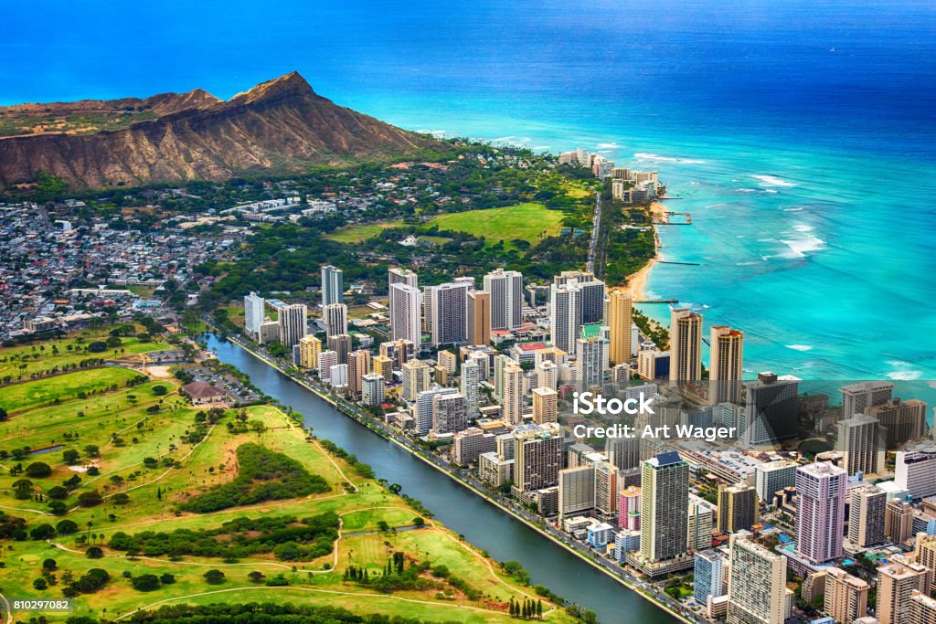 Waikiki and Diamond Head Aerial The beautiful coastline of the Waikiki area of Honolulu Hawaii with the volcanic crater, Diamond Head, in the background shot from an altitude of about 1000 feet during a helicopter photo flight over the island. Hawaii Islands Stock Photo