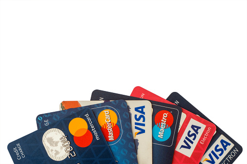 Sarajevo, Bosnia and Herzegovina - Jun 25, 2017: closeup pile of credit cards, Visa and MasterCard, credit, debit and electronic. Isolated on white background with clipping path. Design element.