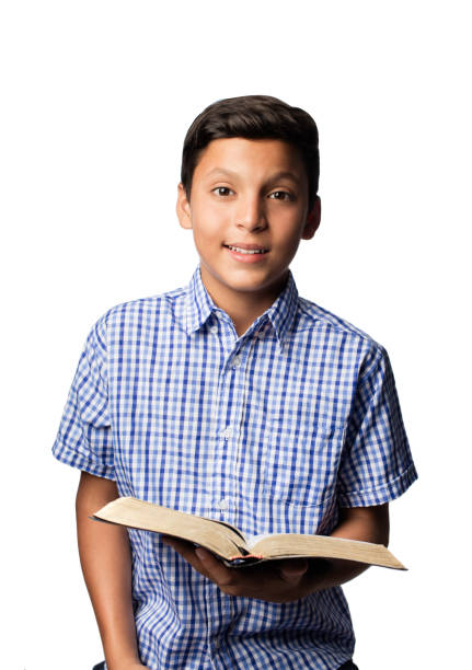 happy latin boy holding bible and looking at camera - bible holding reading book imagens e fotografias de stock