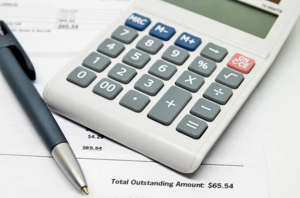 istock Calculating numbers for bill with pen and calculator 810329124