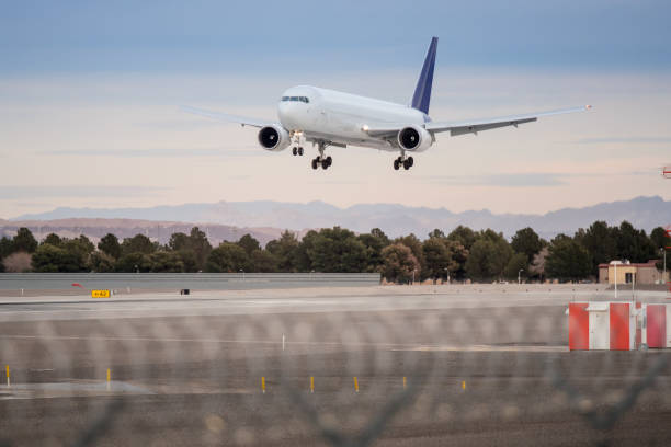 istock Airplane landing on runway with blue sky sunset , no logo 810336128