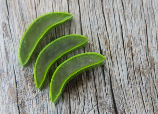 istock Fresh aloe vera on wood texture. 810348034