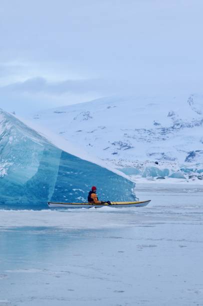 istock A man paddles around giant icebergs in Iceland. 810357494