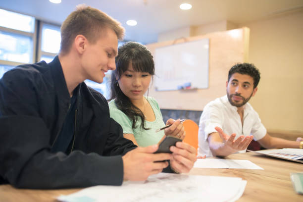 istock Business colleagues checking on smart phone during team meeting 810362426