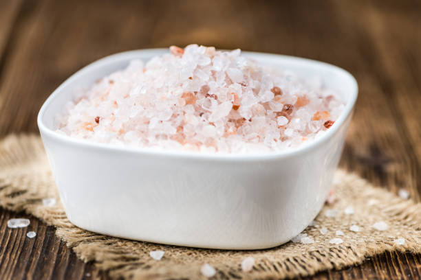 istock Wooden table with Pink Salt (selective focus) 810364716