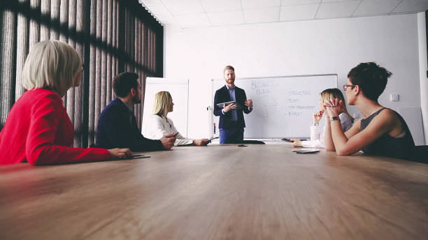 istock Business man presenting new ideas and projects to his team 810364758