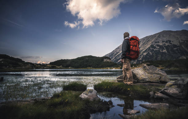 istock Traveler watching the sunset over the mountains 810369952