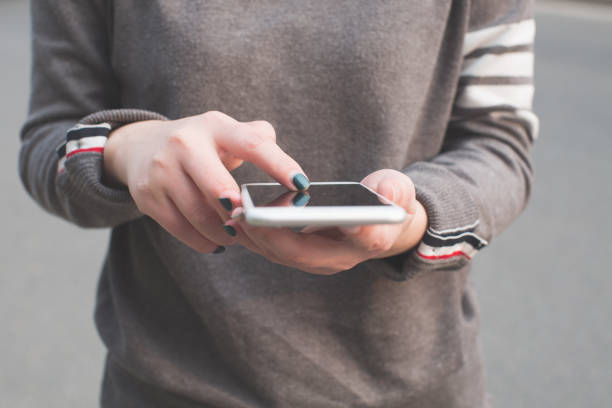 istock Young woman using Mobile phone outdoors 810372400