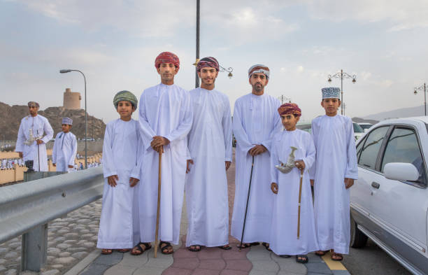 omani men in tradtional outfits on a street in Nizwa stock photo