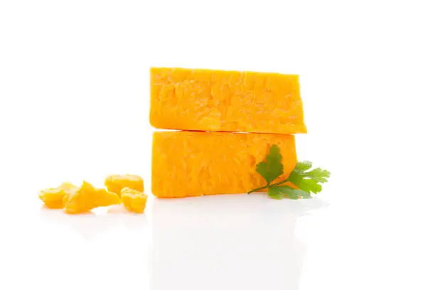 Delicious cheddar cheese isolated on white background. Culinary traditional cheese eating.