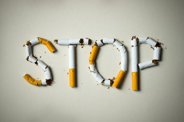 Stop smoking concept The word stop spelled using cigarettes on grey background quit smoking stock pictures, royalty-free photos & images