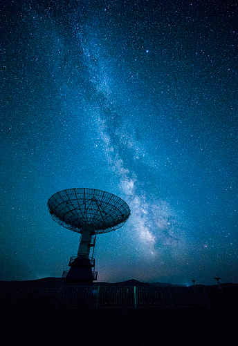 Satellite dish under a starry sky