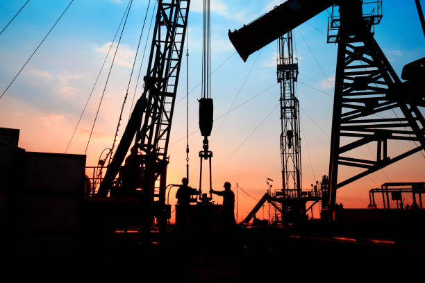 istock oil field, the oil workers are working 810449614