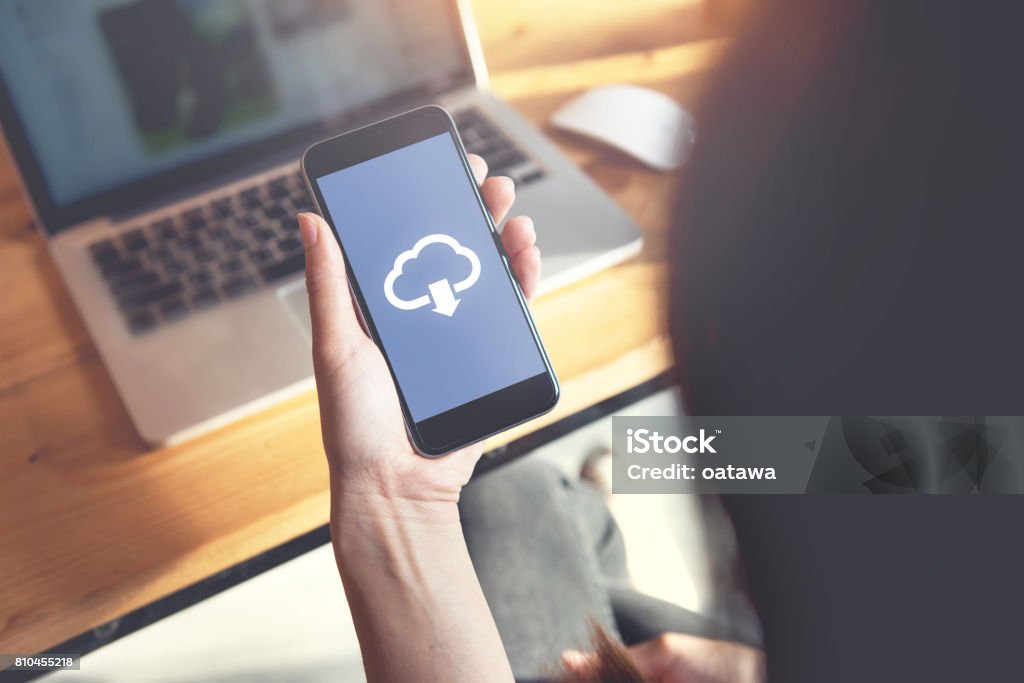 Cloud download on mobile smartphone. Closeup hand of woman with Cloud download on mobile smartphone. Storage Compartment Stock Photo