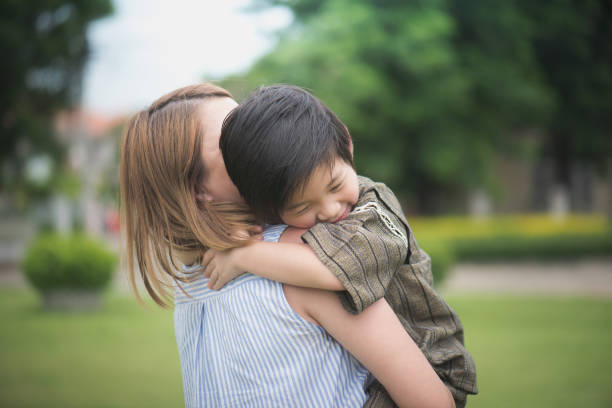 istock Asian mother and her son playing in the park 810469286