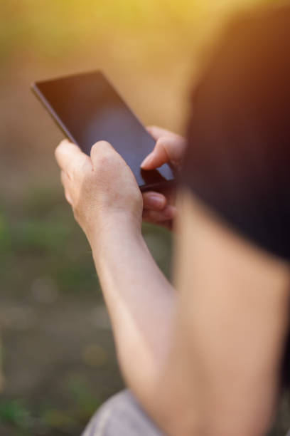 istock Female person using smartphone outdoors 810496896