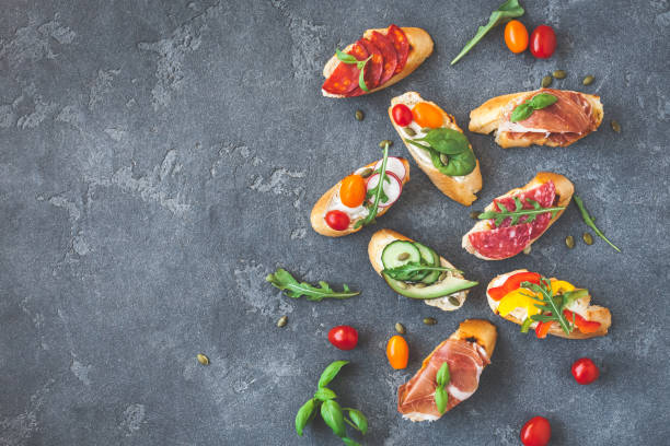 istock Traditional spanish tapas on black background. Flat lay, top view 810505504
