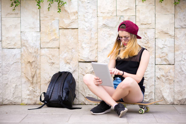 istock Happy young woman with digital tablet 810511652