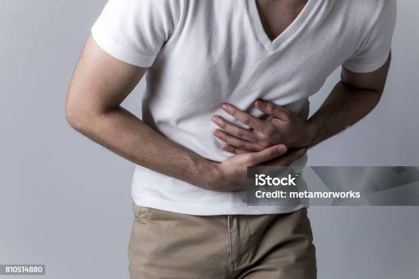 Young Man Having A Stomachache Stock Photo - Download Image Now - Norovirus, Men, Stomach Cancer