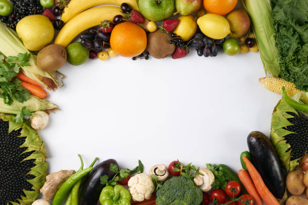istock Top view of a rainbow colored fruit and vegetables on a white background with copy space 810515370
