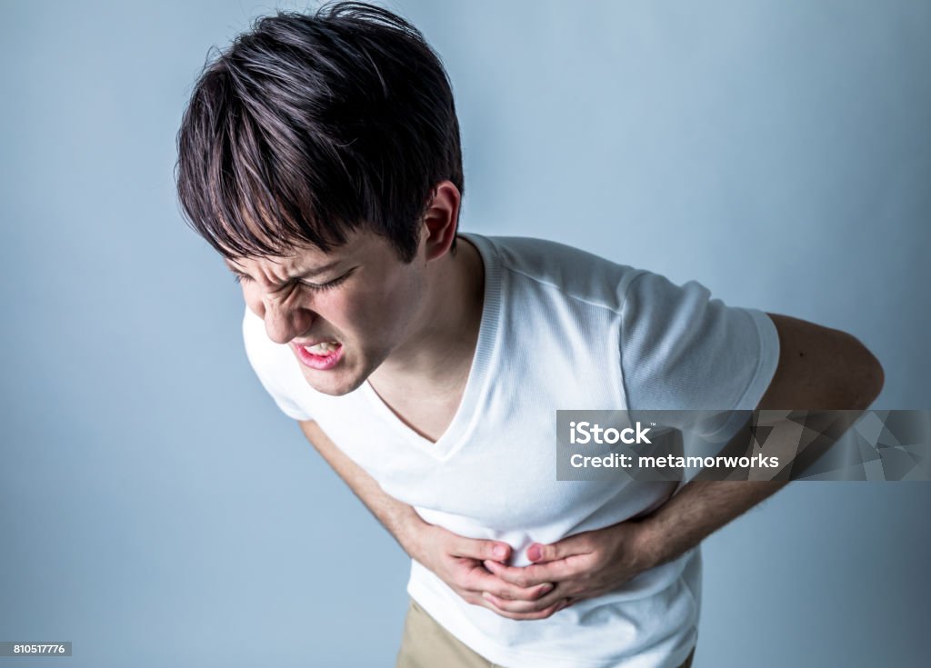 young man having a stomachache Stomachache Stock Photo