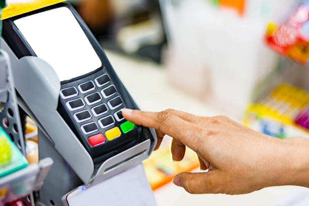istock woman shopping entering a security pin on the terminal 810524088