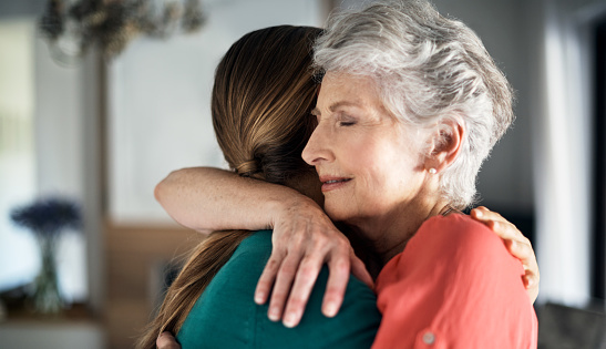 Support, trust and hands, senior care in therapy or grief counseling session. Love, care and understanding between elderly and and caregiver. Hope, empathy and help in time of need for mental health.